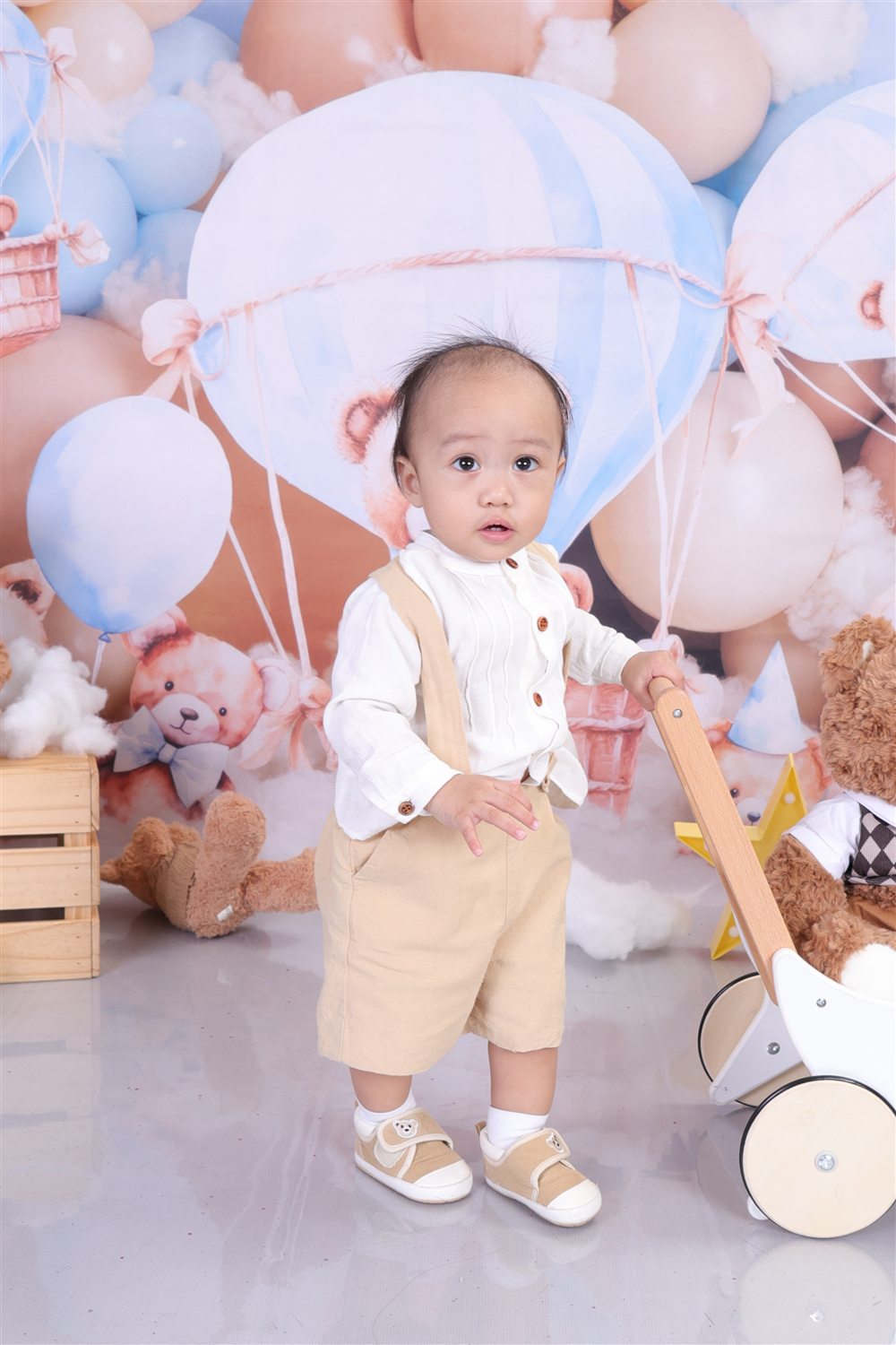 Jaden Matthew standing in his teddy bear birthday setup